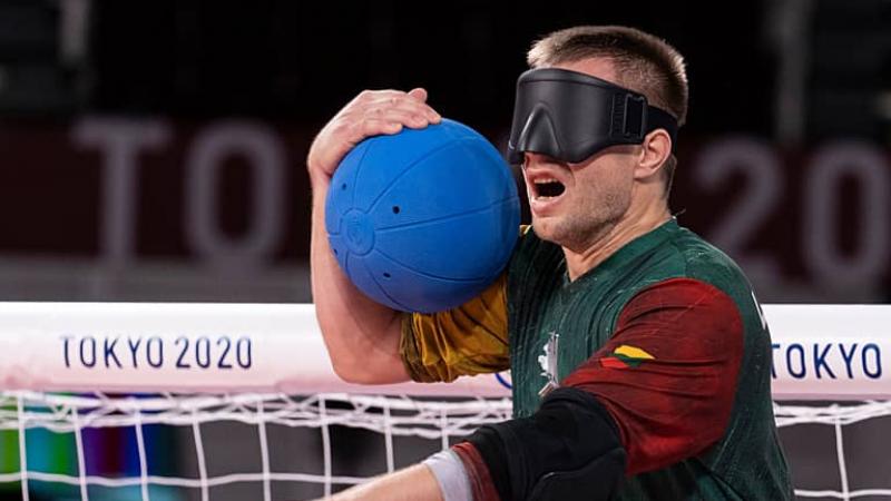 Goalball player Genrik Pavliukianec calling out while holding the ball 