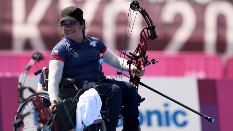 Female Para archer Mariana Zuniga smiling while holding her bow 