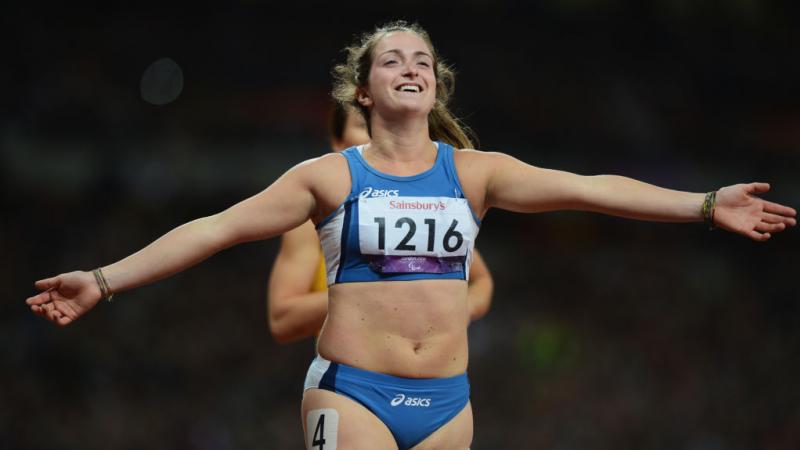 Para sprinter Martina Caironi holds out her arms as she crosses the finish line