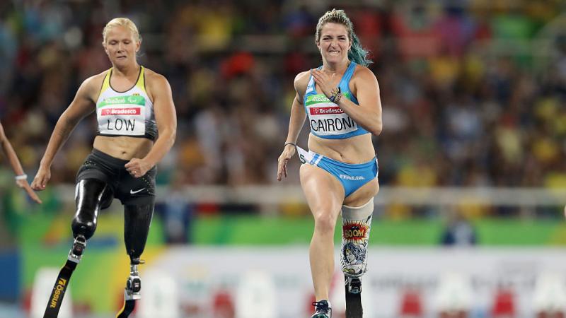 Para sprinter Martina Caironi running with a prosthetic leg against another athlete