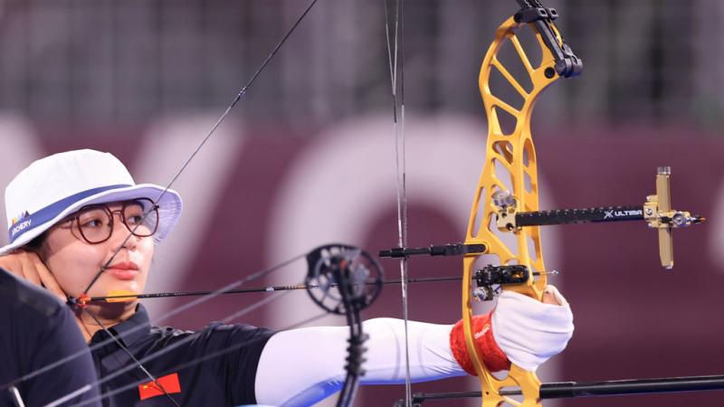 Para archer Chen Minyi prepares to shoot an arrow in competition 
