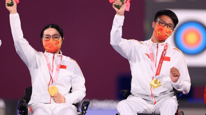 Para archers Zhang Tianxin and Chen Minyi celebrate with their gold medals 