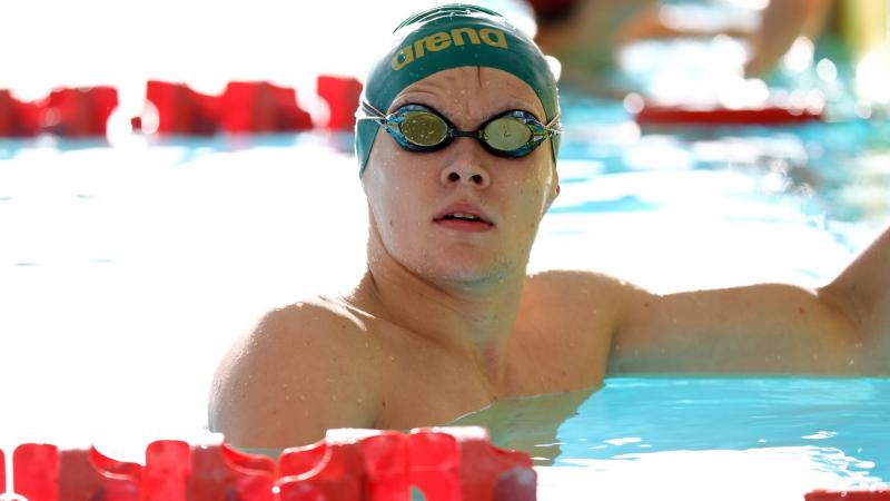 A male swimmer with his head outside the water