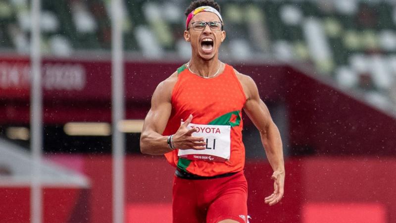 A male runner shouting in a stadium