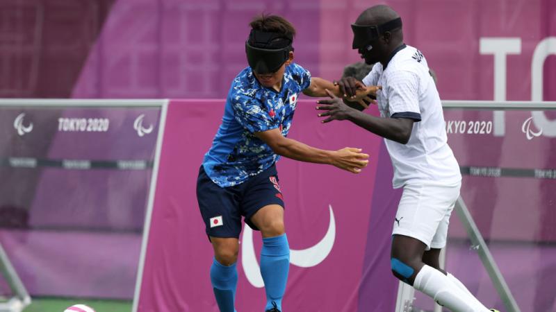 blind football Babacar Niang tackles another player for the ball 