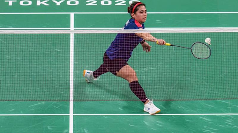 Female Para badminton player Leani Ratri Oktila takes a shot