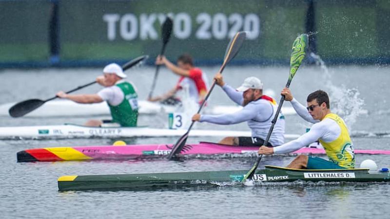 four male Para canoeists paddling in a race