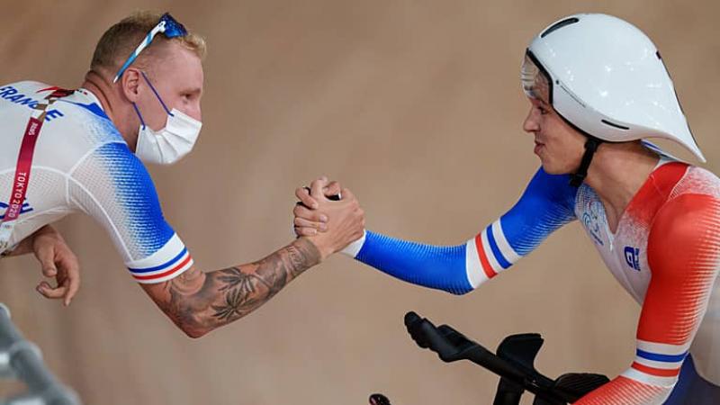 Para cyclist Alexandre Leaute high fives a member of his team