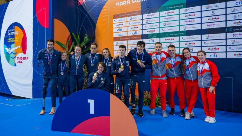 A podium of a relay swimming race with 12 athletes