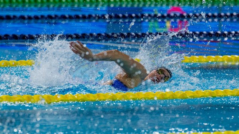 A female swimmer competing in a pool