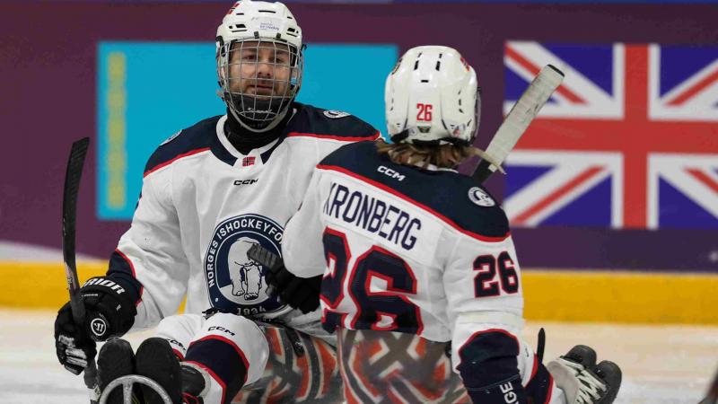 Para Ice Hockey players celebrate a goal