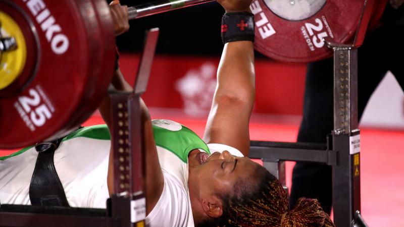 Lucy Ejike of Nigeria lifts weights during competition