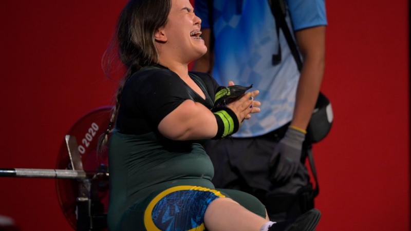A female Para powerlifter reacts after a lift.