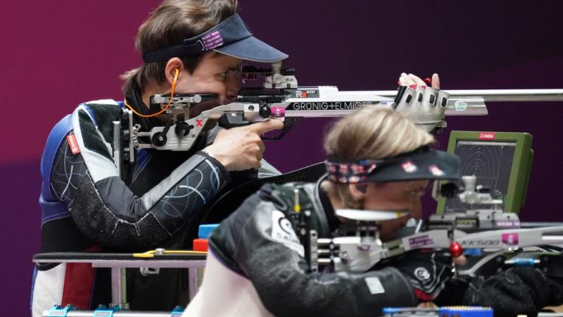 Two female shooters side by side aiming for the target at the Tokyo 2020 Paralympics.