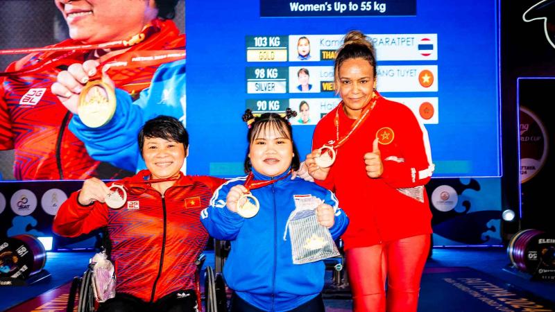 Medallists pose at podium