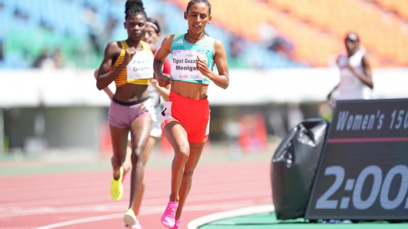 A female runner ahead of two competitors