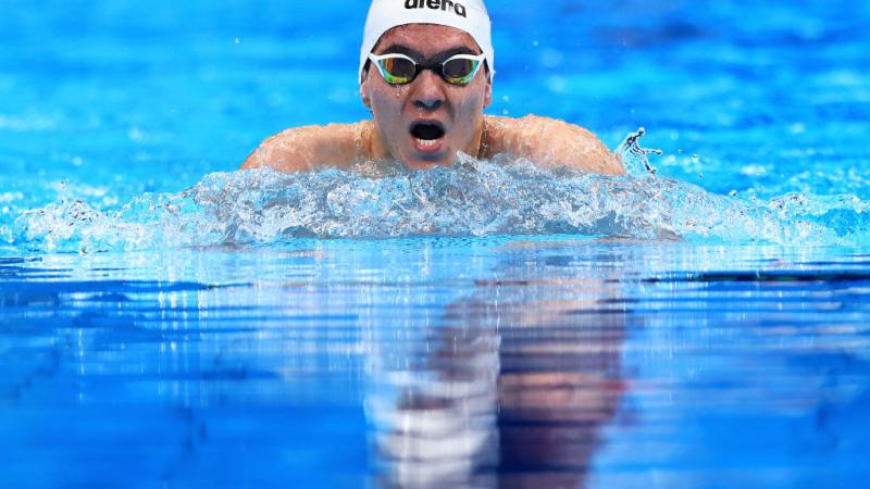 A male Para swimmer competes