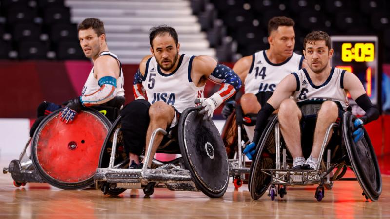 Four wheelchair rugby athletes in competition