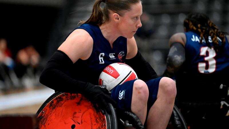 Sarah Adam carries the ball during a wheelchair rugby match