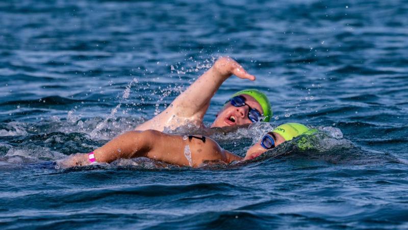 Two Para swimmers in an open water competition