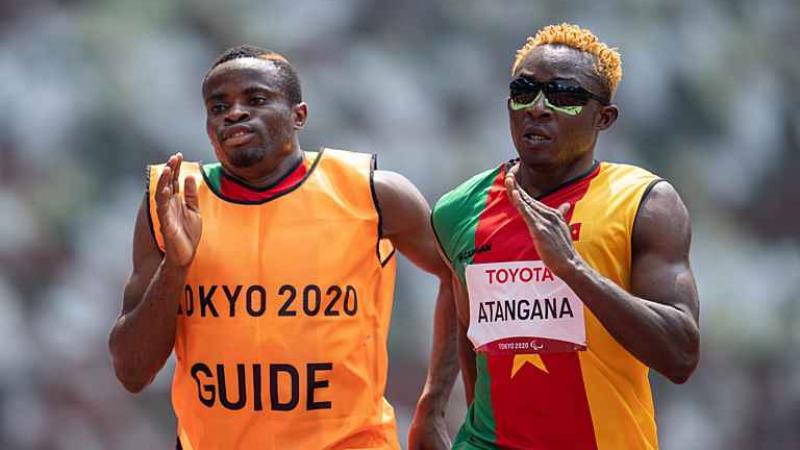 Vision impaired sprinter Guillaume Junior Atangana running with his guide
