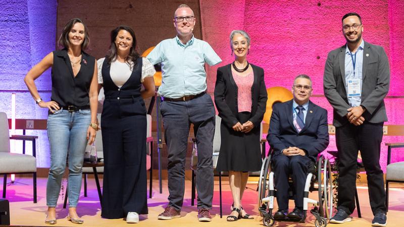 A group of people with disabilities standing on a stage 