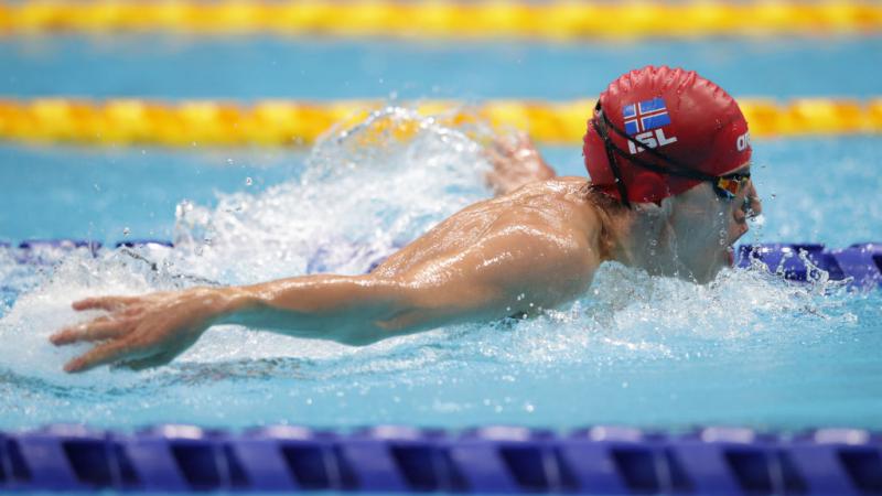 male Para swimmer Mar Gunnarsson performing a butterfly stroke in the pool 
