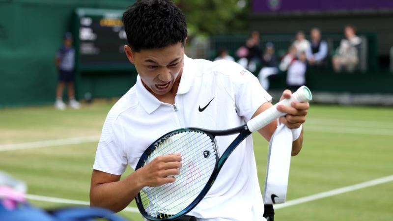 Tokito Oda playing air guitar with his racquet 