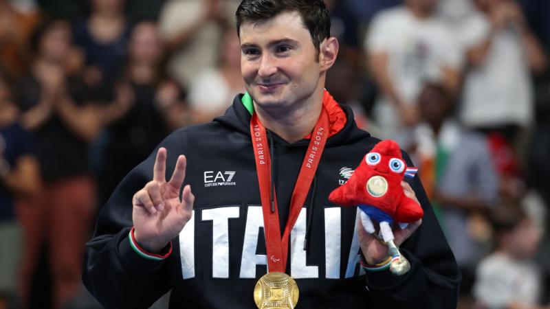 Francesco Bocciardo poses for the camera with his gold medal