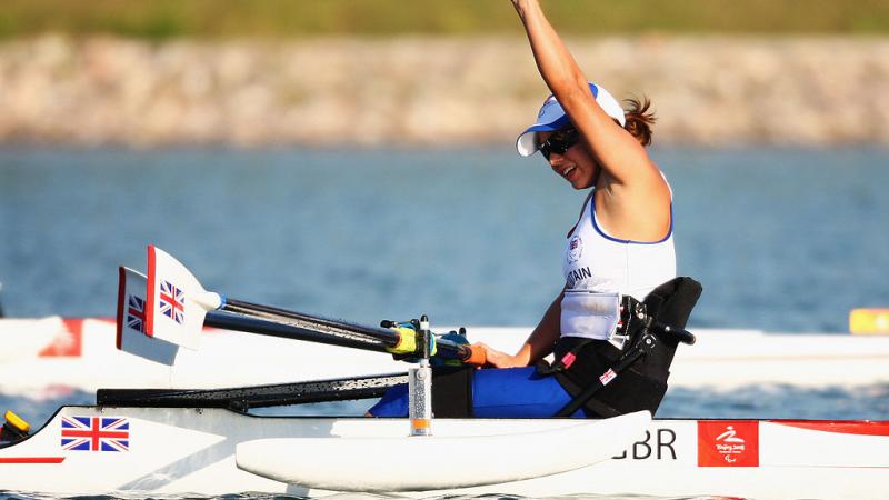 A female Para rowing athlete reacts after a competition