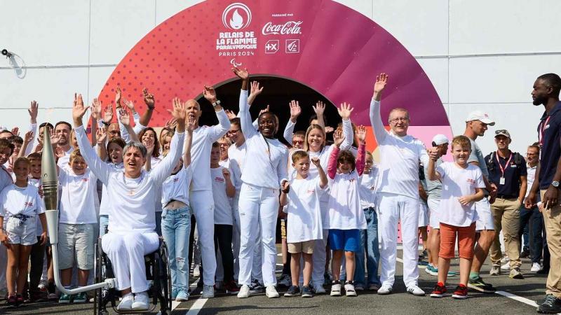 a group of Para athletes cheering outside the Channel Tunnel 