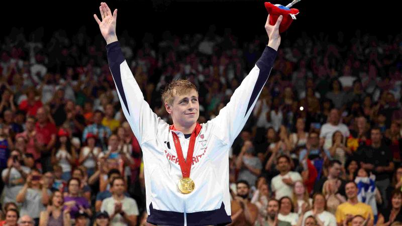 An athlete celebrates on podium