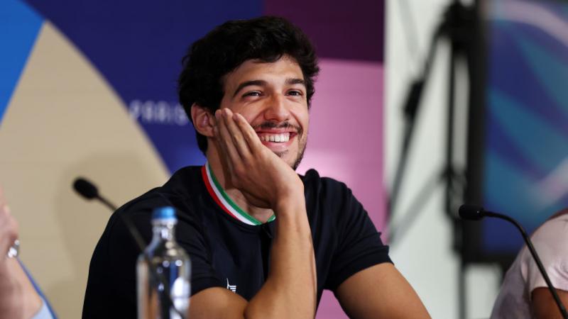 Para swimmer Simone Barlaam smiling and resting his face on his hand
