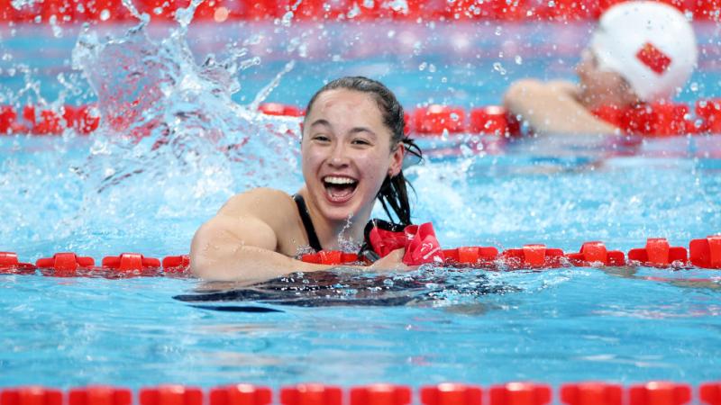 A woman in a swimming pool smiles
