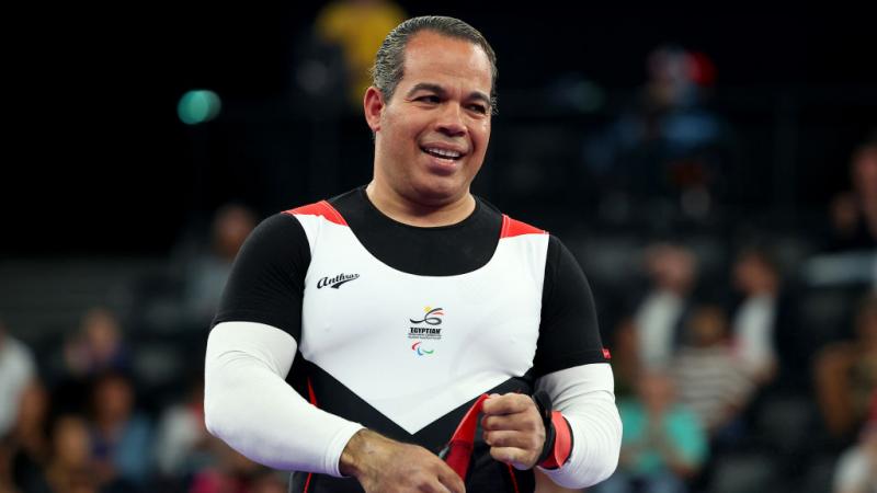 Powerlifter Sherif Osman smiles on stage