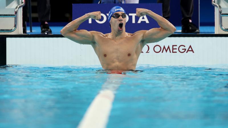 Para swimmer Simone Barlaam roars in celebration in the pool