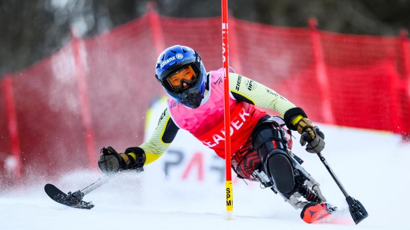 A female Para alpine sit skier is in action