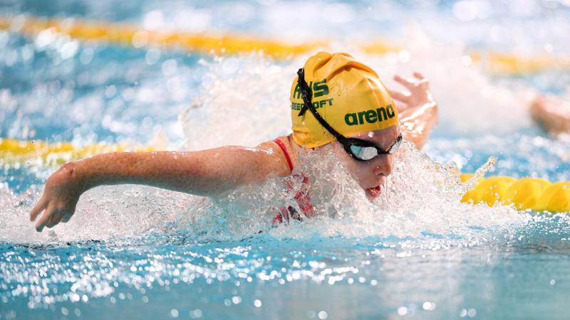 A female athlete with the cap of Australia swimming butterfly