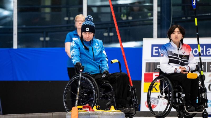 Female wheelchair curling athlete in action