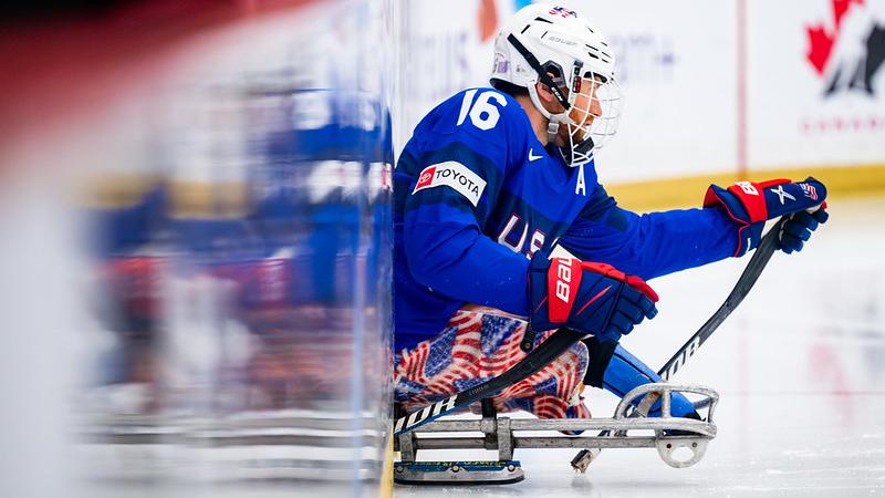 A male Para ice hockey player entering the rink