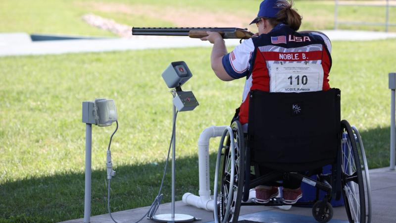 A female Para trap shooter in a wheelchair during a competition