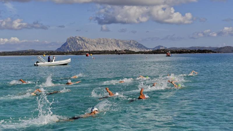 A group of 13 Para swimmers in an open water competition