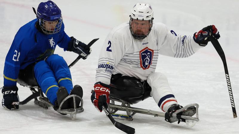A Kazak and a French Para ice hockey player in a game