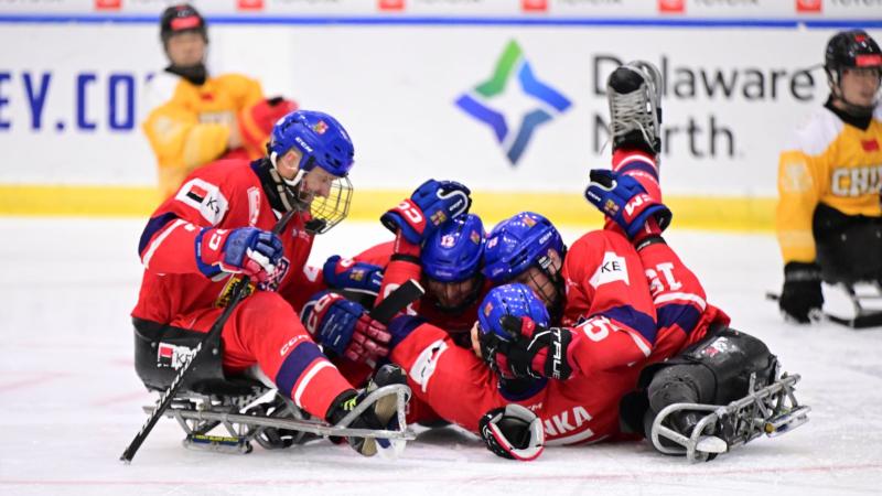 A group of Czech Para ice hockey players celebrating on ice