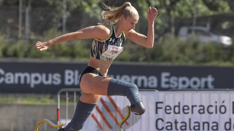 A woman in prosthetic legs running in a competition