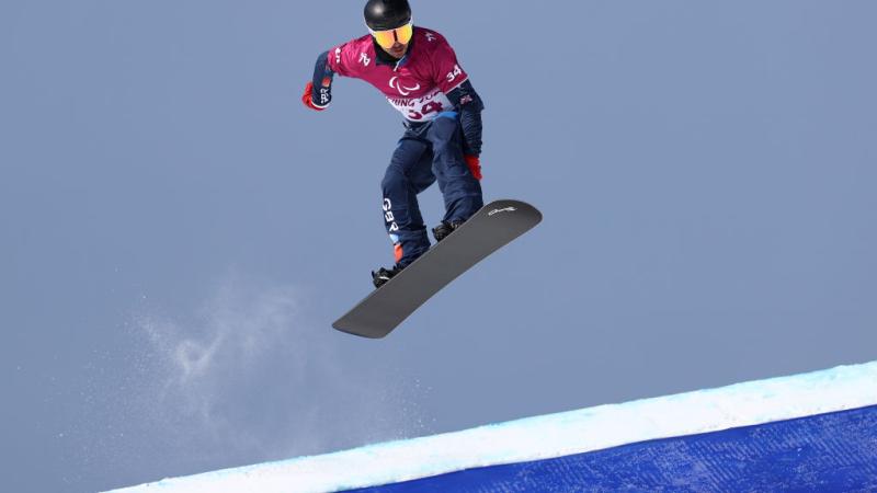 A male Para snowboarder in competition