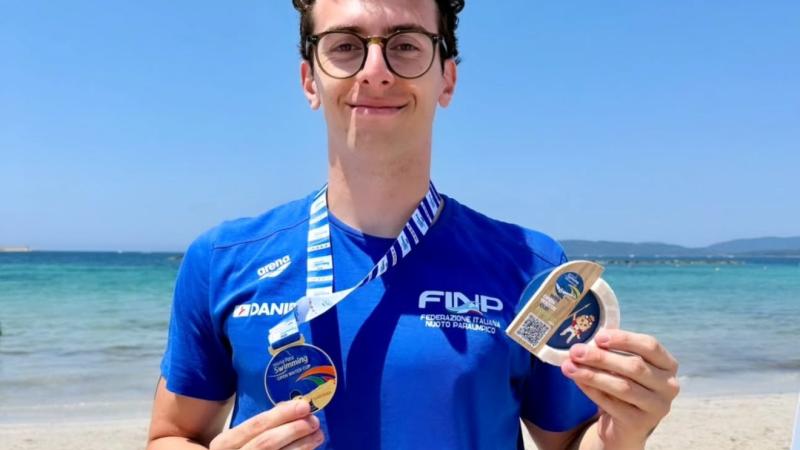 An athlete poses with his medal