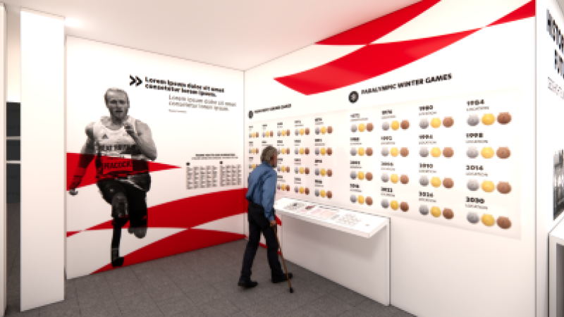 A wall displaying British Paralympian Jonnie Peacock appears to the left. To the right, a wall displaying the gold, silver and bronze medals from all Summer and Winter Games editions appear in chronological order.