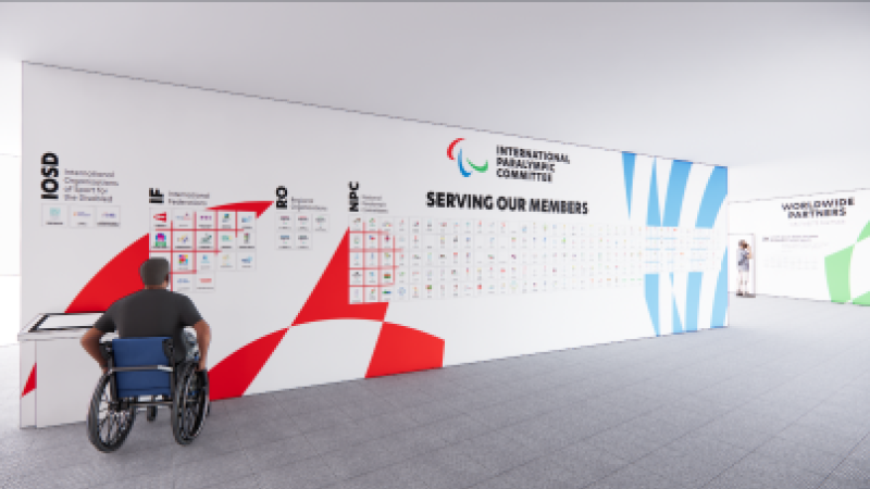 A large wall displays the logos and emblems of all IPC Member organisations. At the back, another wall displays the Worldwide Paralympic Partner logos.