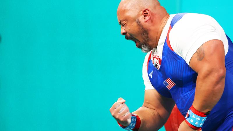 An athlete gestures after a lift